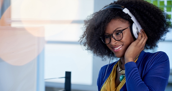 A woman answers the phone and provides customer support at a domestic call center