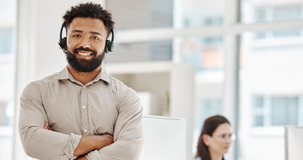 A man and woman working at a domestic customer contact center