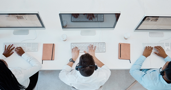 People at computers supporting customers via a domestic customer contact center