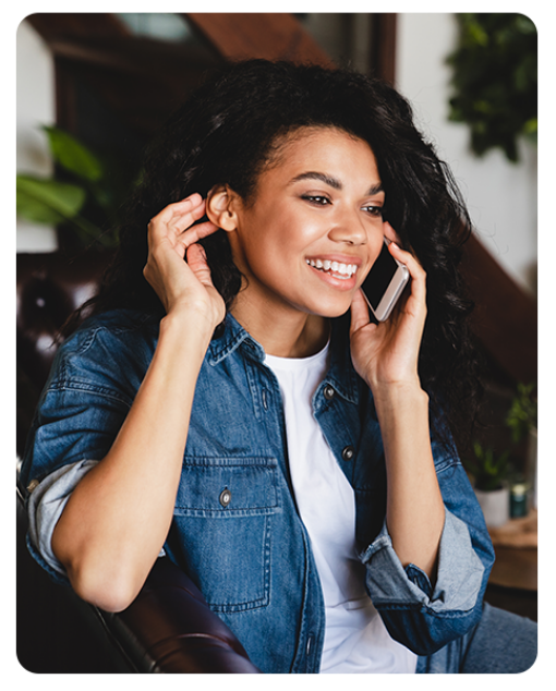 A woman smiling while on the phone with a call center
